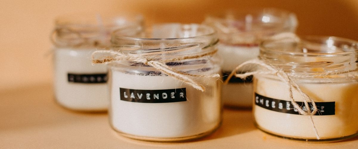 White candles in white jars