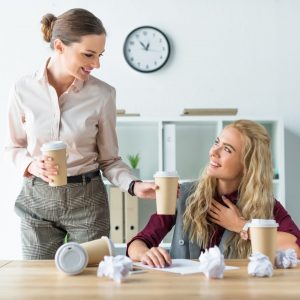 Co-worker giving coffee to a colleague